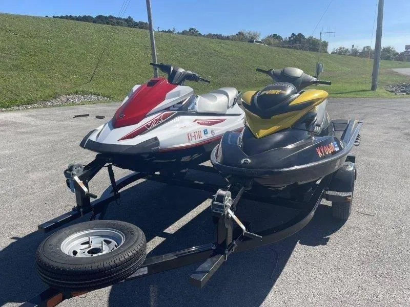 Slide: The Image of Two 2007 Sea-Doo RXP 215 jet skis on a trailer in a parking lot. - 19