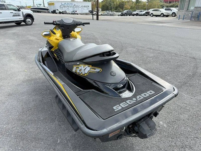 Slide: The Image of 2007 Sea-Doo RXP 215 jet ski, yellow and black, parked on asphalt. - 4