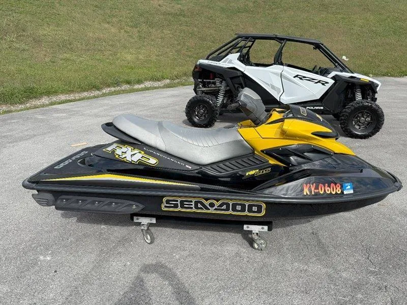 Slide: The Image of 2007 Sea-Doo RXP 215 jet ski parked beside a white off-road vehicle. - 5