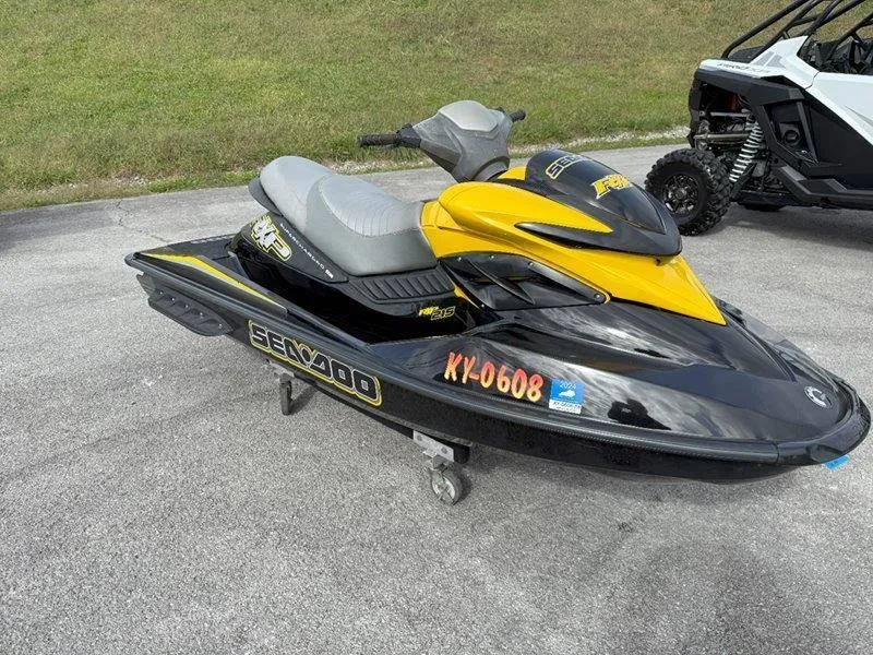 Slide: The Image of 2007 Sea-Doo RXP 215 jet ski, yellow and black, parked on pavement. - 7