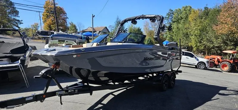 Slide: The Image of 2025 MasterCraft XT24 boat on trailer in outdoor setting. - 0