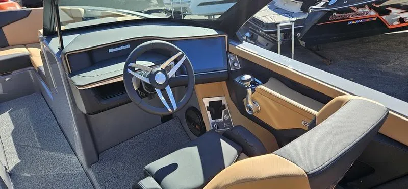 Slide: The Image of Interior of 2025 MasterCraft XT24 boat with modern steering and dashboard. - 12