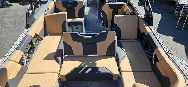 Slide: The Image of 2025 MasterCraft XT24 boat interior with tan and black seating. - 15