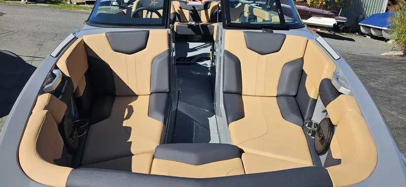 Slide: The Image of 2025 MasterCraft XT24 boat interior with tan and gray seating. - 6