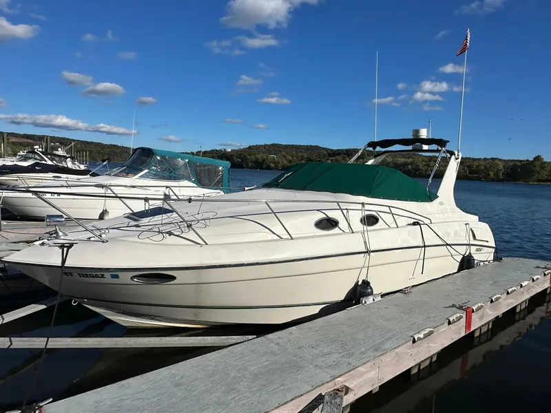 Slide: The Image of 1997 Regal 292 Commodore boat docked on a sunny day with clear skies. - 1
