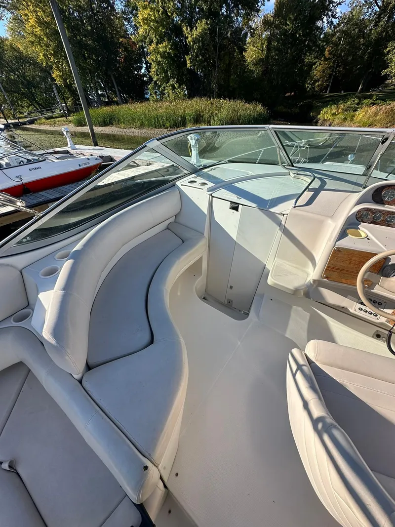 Slide: The Image of 1997 Regal 292 Commodore boat interior with white seating and steering wheel. - 12