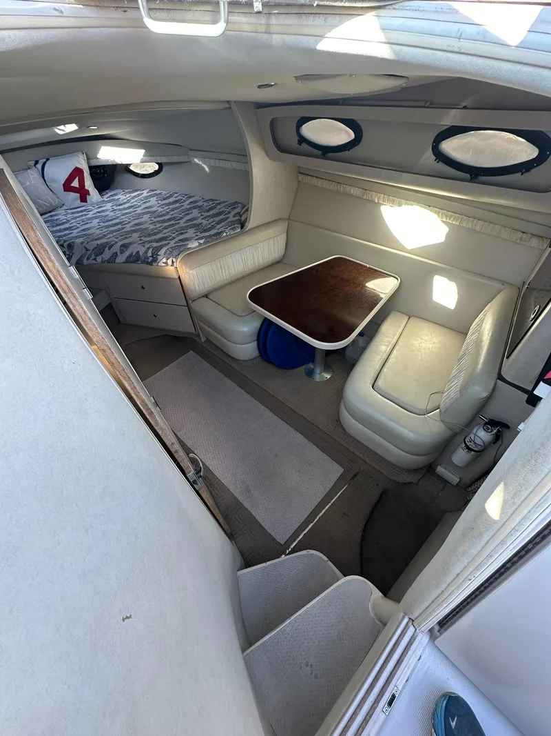 Slide: The Image of Interior of 1997 Regal 292 Commodore boat with seating and sleeping area. - 16