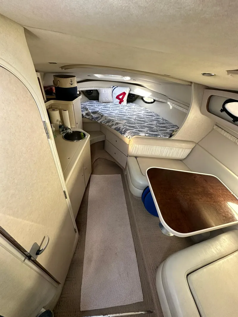 Slide: The Image of Interior of 1997 Regal 292 Commodore boat with cozy cabin and seating area. - 17