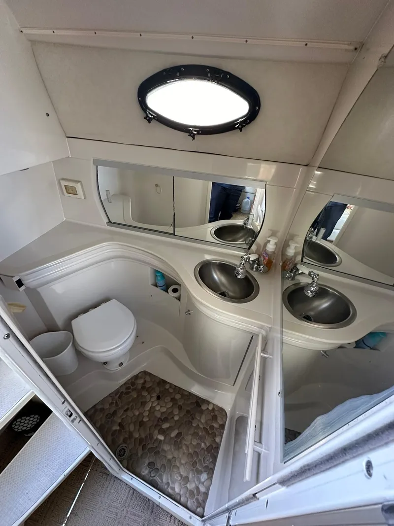 Slide: The Image of 1997 Regal 292 Commodore bathroom with sink, toilet, and mirror. - 18
