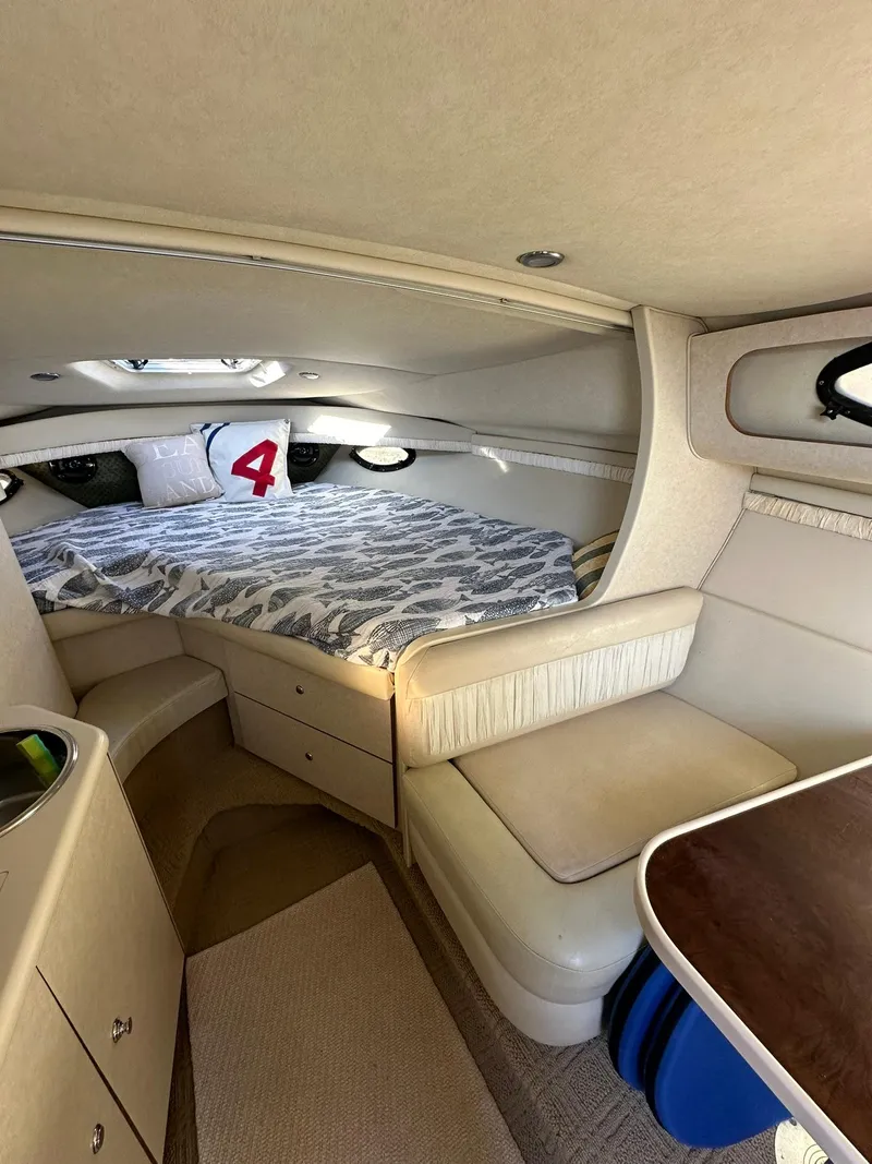 Slide: The Image of Interior of 1997 Regal 292 Commodore boat with cozy cabin and seating area. - 20