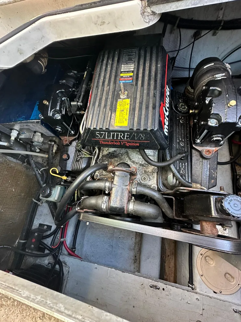 Slide: The Image of Engine of 1997 Regal 292 Commodore boat, featuring a 5.7L V8 Thunderbolt ignition system. - 24