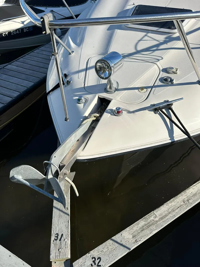 Slide: The Image of 1997 Regal 292 Commodore boat docked with anchor and spotlight visible. - 26