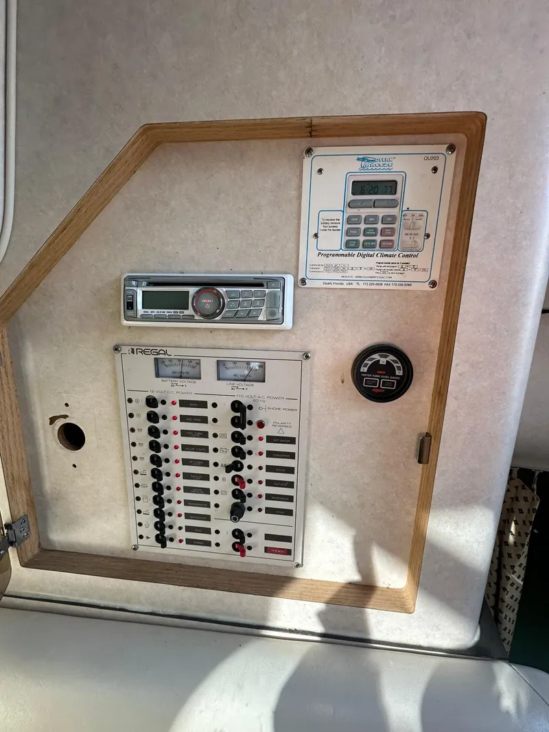 Slide: The Image of Control panel of a 1997 Regal 292 Commodore boat with switches and gauges. - 30