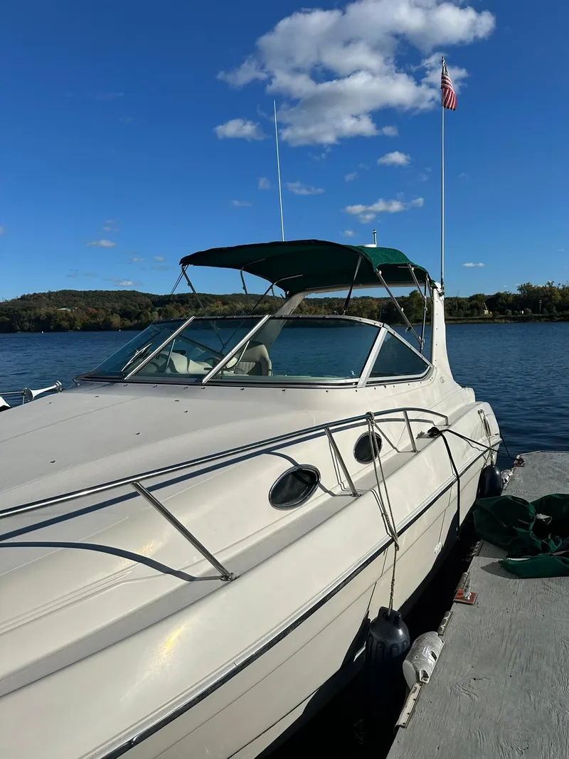 Slide: The Image of 1997 Regal 292 Commodore boat docked on a sunny day with blue sky. - 4