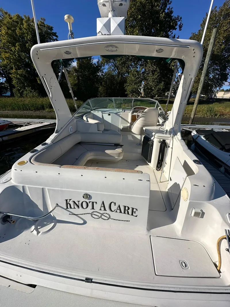 Slide: The Image of 1997 Regal 292 Commodore boat named "Knot A Care" docked in a marina. - 7