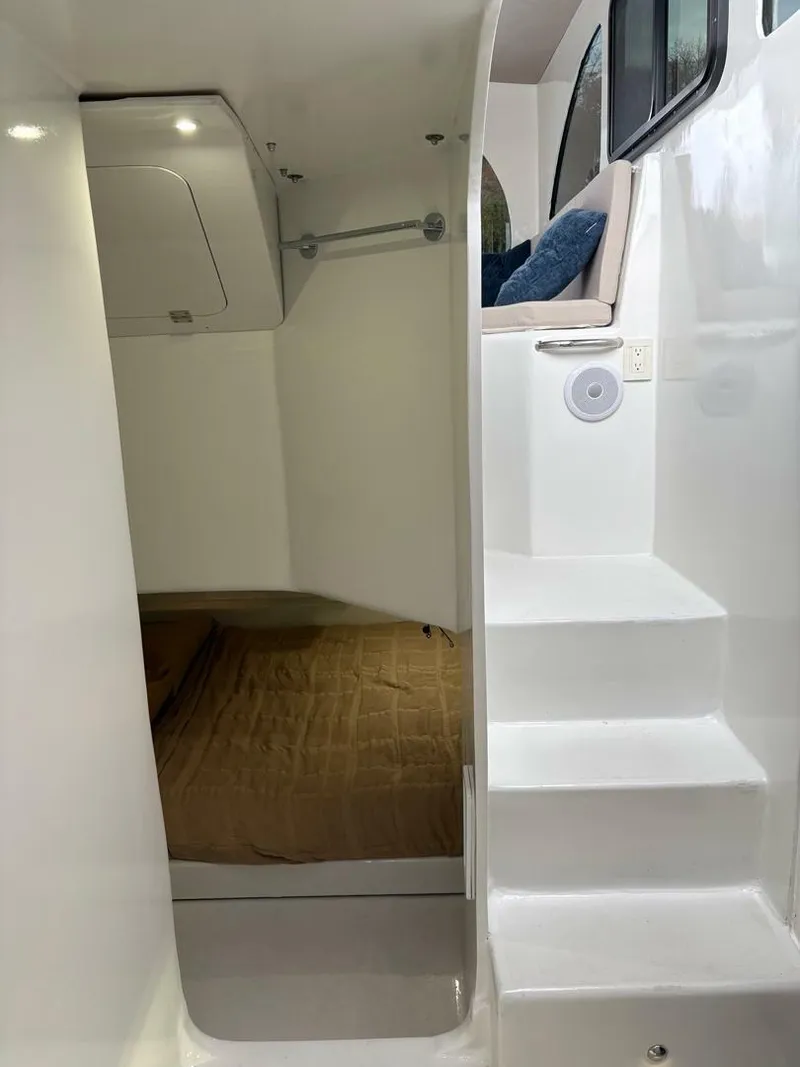 Slide: The Image of 2023 Millennium Marine NuWave Walkaround interior with stairs and cabin area. - 13