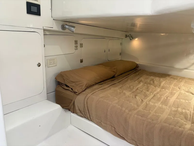 Slide: The Image of 2023 Millennium Marine NuWave Walkaround cabin with cozy bed and modern lighting. - 15