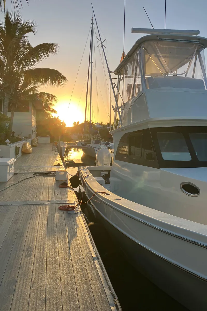 Slide: The Image of 2023 Millennium Marine NuWave Walkaround boat docked at sunset. - 2