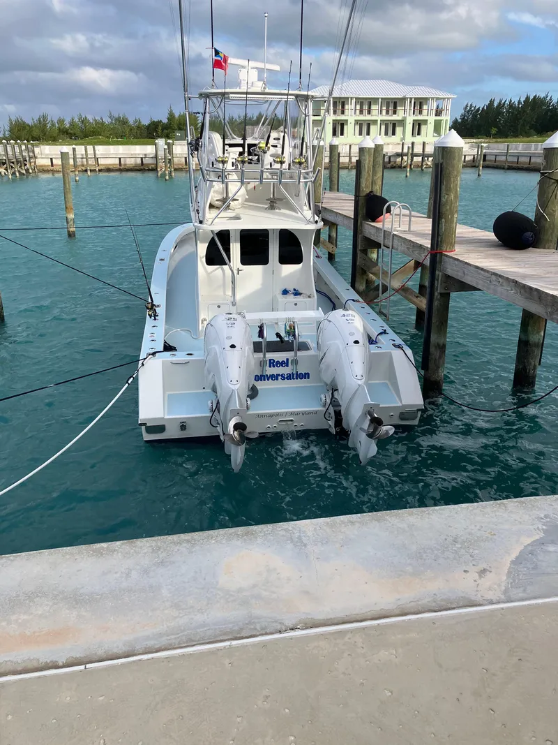 Slide: The Image of 2023 Millennium Marine NuWave Walkaround boat docked in a marina. - 35