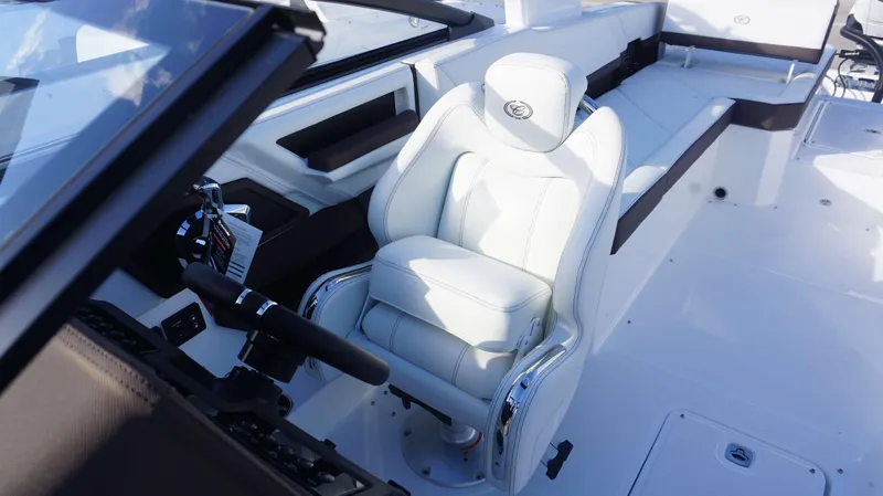 Slide: The Image of 2025 Cobalt R8 boat interior with luxurious white captain's seat and modern controls. - 10
