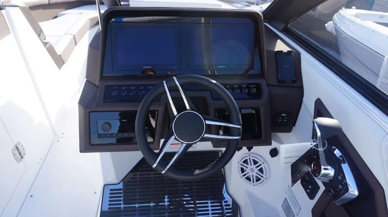 Slide: The Image of 2025 Cobalt R8 boat dashboard with dual screens and modern steering wheel. - 14