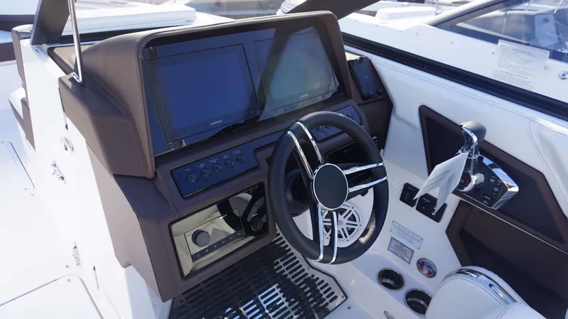 Slide: The Image of 2025 Cobalt R8 boat dashboard with dual screens and modern steering wheel. - 15