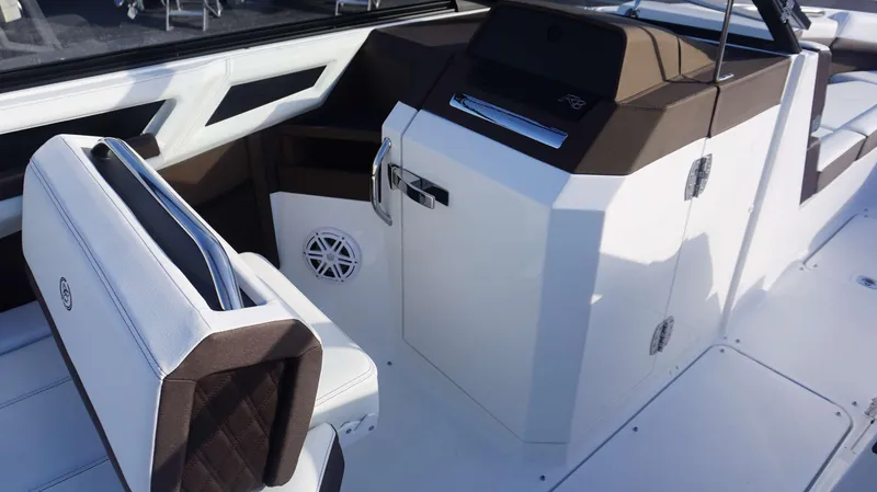 Slide: The Image of 2025 Cobalt R8 boat interior with white and brown seating and modern design. - 16