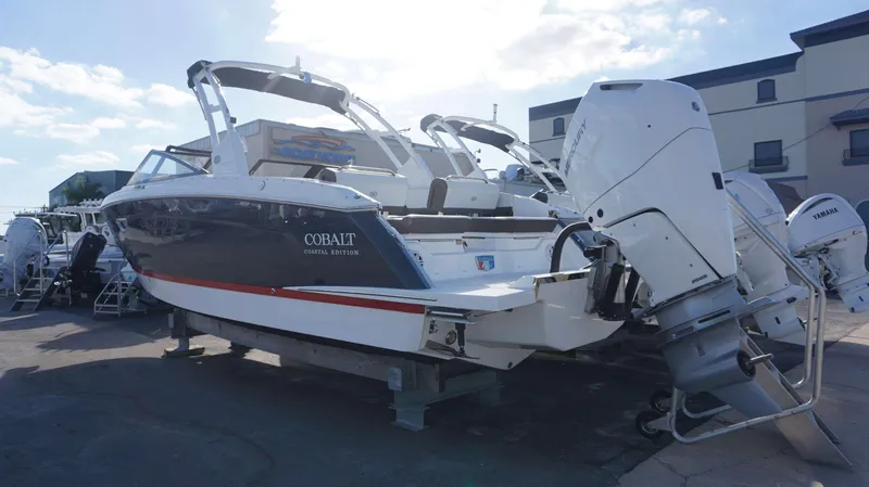 Slide: The Image of 2025 Cobalt R8 boat with outboard motor in a marina setting. - 3