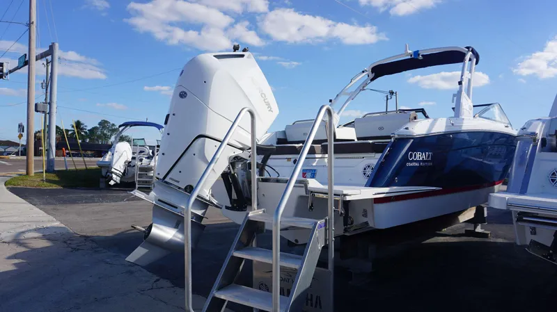 Slide: The Image of 2025 Cobalt R8 boat with outboard motor, displayed outdoors under blue sky. - 4