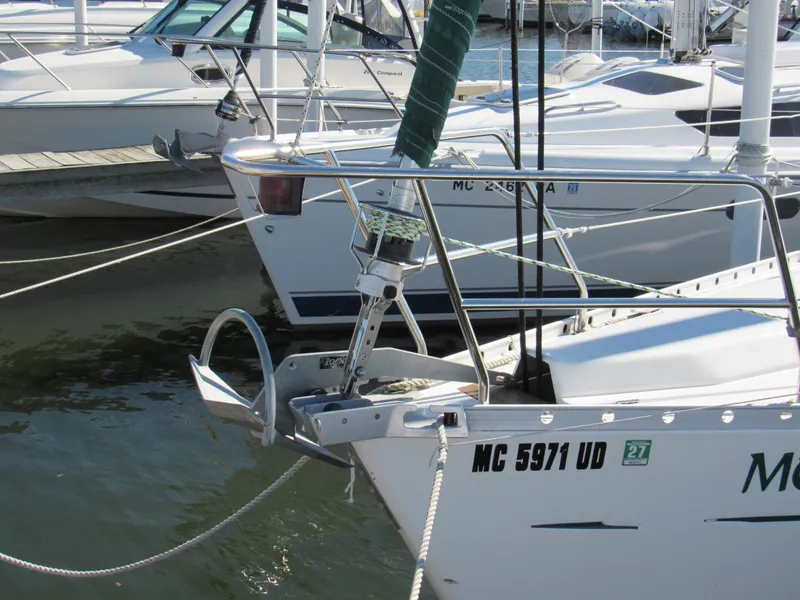 Slide: The Image of Beneteau 381 sailboat from 1999 docked, featuring anchor and registration number. - 1