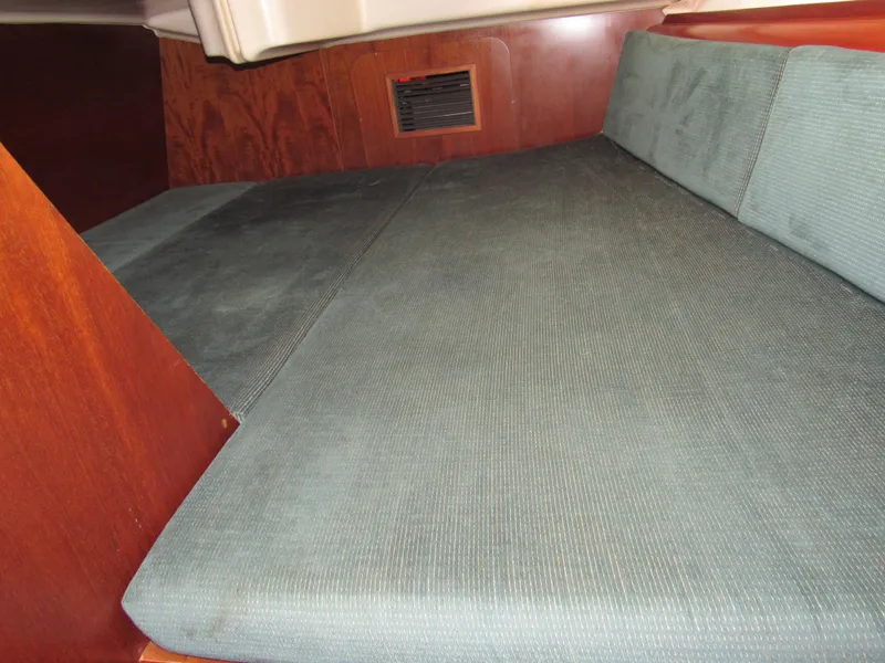 Slide: The Image of Interior cabin of 1999 Beneteau 381 sailboat with cushioned seating. - 11