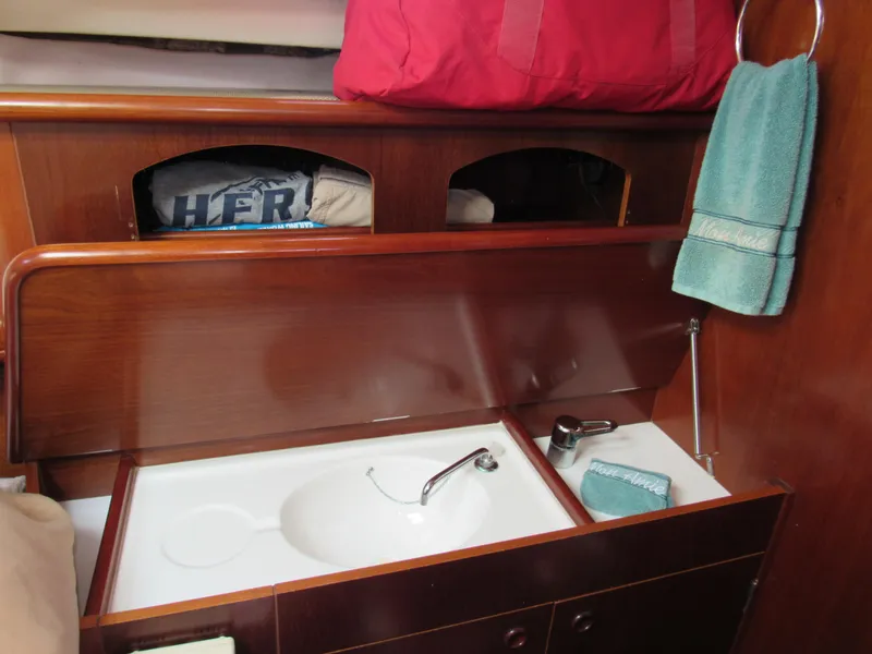 Slide: The Image of Interior of 1999 Beneteau 381 sailboat with sink, storage, and towels. - 13