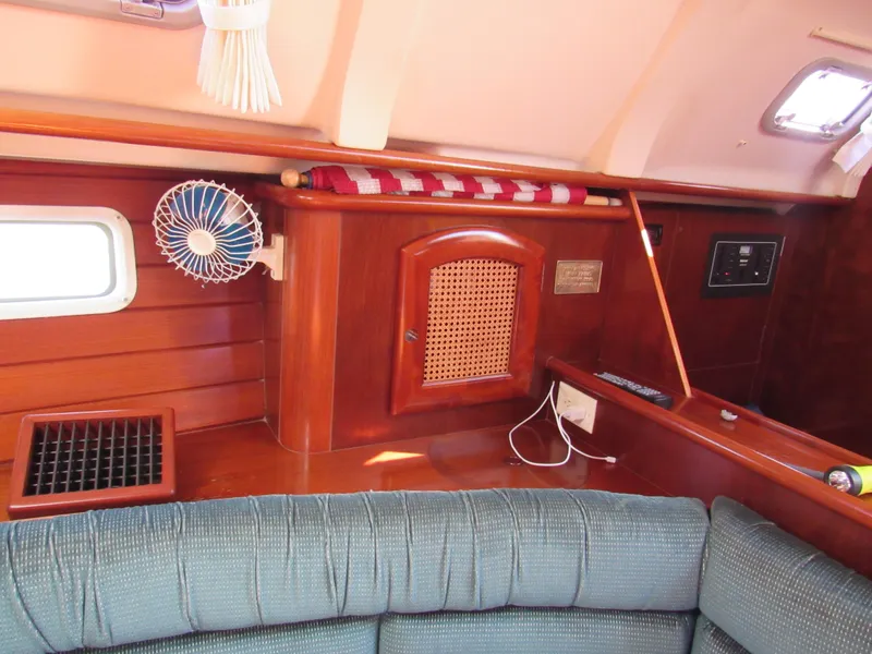 Slide: The Image of Interior of 1999 Beneteau 381 sailboat with wood paneling and seating area. - 14