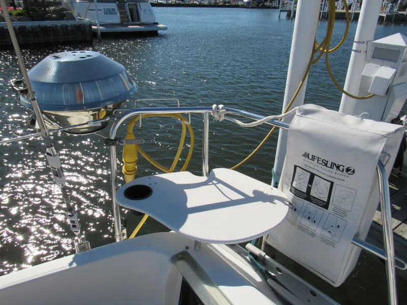 Slide: The Image of Sailboat deck with grill and lifesaving equipment, Beneteau 381, 1999 model, docked by the water. - 18