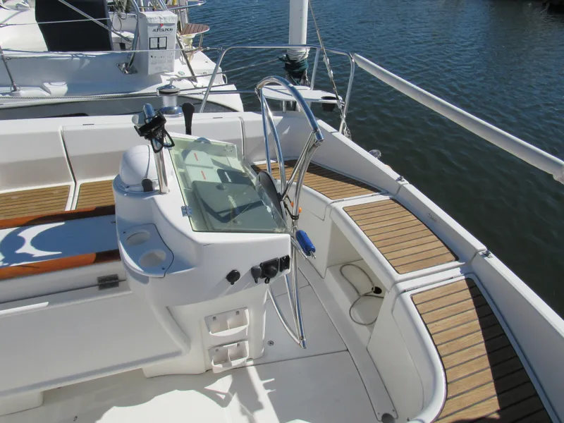 Slide: The Image of Cockpit of 1999 Beneteau 381 sailboat with wooden seating and steering wheel. - 24