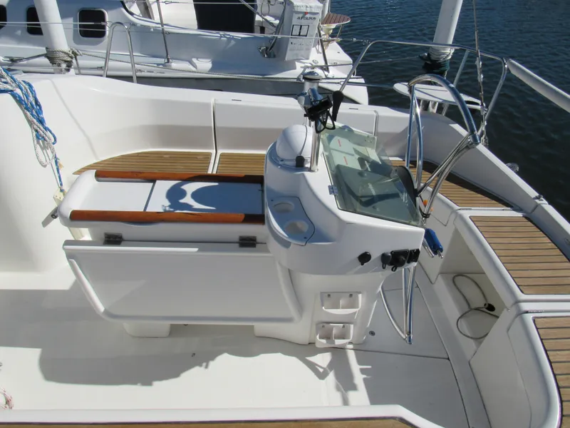 Slide: The Image of Cockpit of 1999 Beneteau 381 sailboat with steering wheel and seating area. - 25