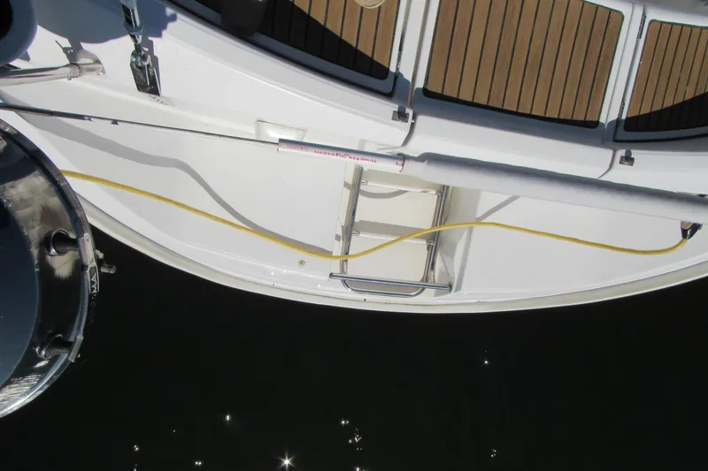 Slide: The Image of Deck view of a 1999 Beneteau 381 sailboat with ladder and yellow cable. - 26