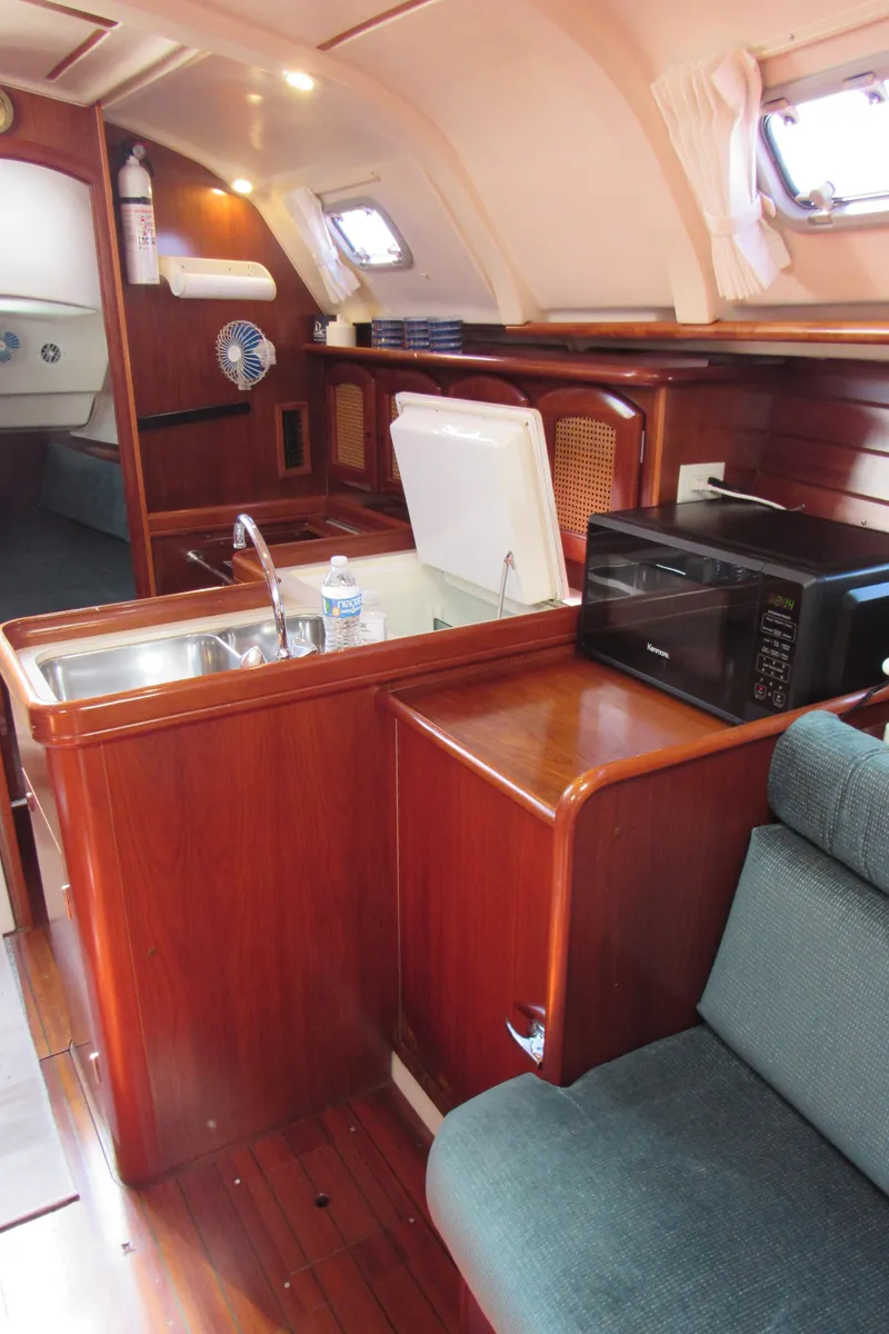 Slide: The Image of 1999 Beneteau 381 yacht interior with kitchen, sink, and microwave. - 7