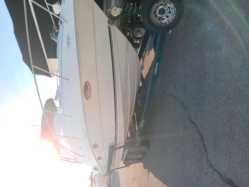Slide: The Image of 2001 Celebrity 280 Express Cruiser on trailer, parked in sunlight. - 1