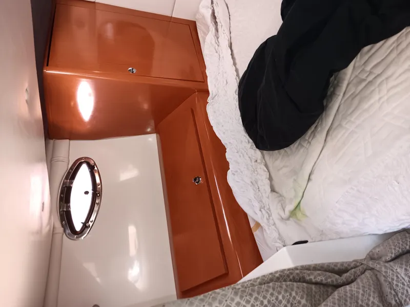 Slide: The Image of Interior cabin of 2001 Celebrity 280 Express Cruiser with bed and wooden cabinets. - 15