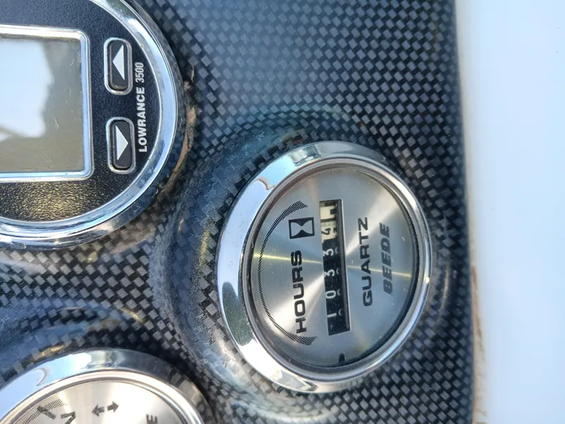 Slide: The Image of Dashboard of 2001 Celebrity 280 Express Cruiser with hour meter and Lowrance 3500 display. - 19