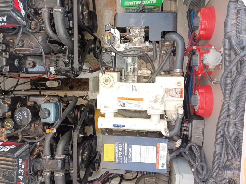 Slide: The Image of Engine compartment of a 2001 Celebrity 280 Express Cruiser with visible mechanical components. - 24