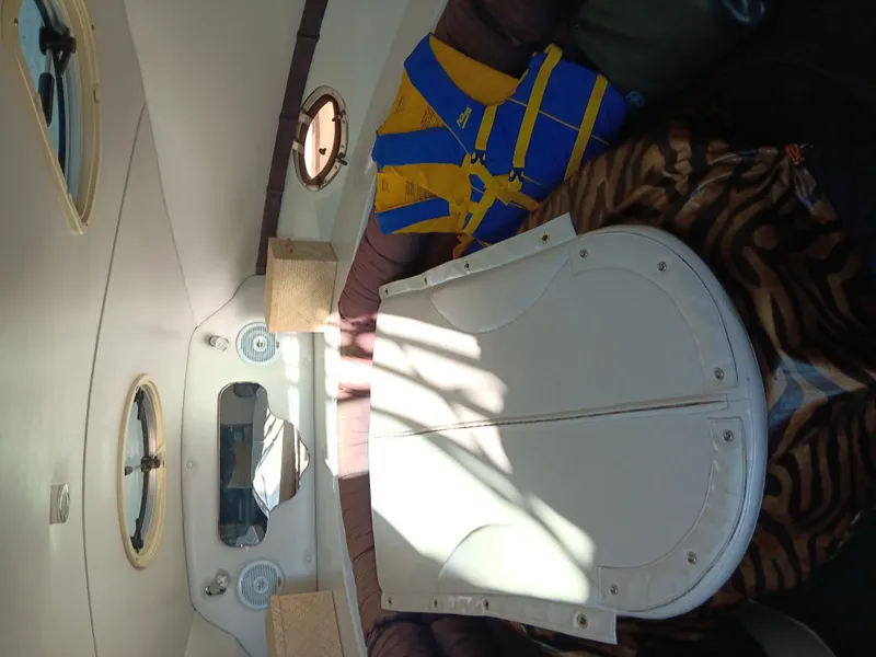 Slide: The Image of Interior of 2001 Celebrity 280 Express Cruiser with life jacket and table. - 9