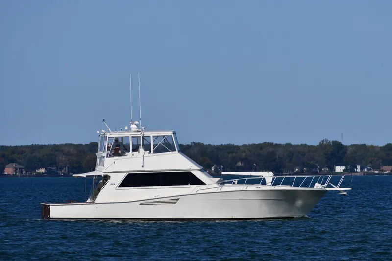 Slide: The Image of 1990 Viking 53 Convertible yacht cruising on a calm blue sea. - 1