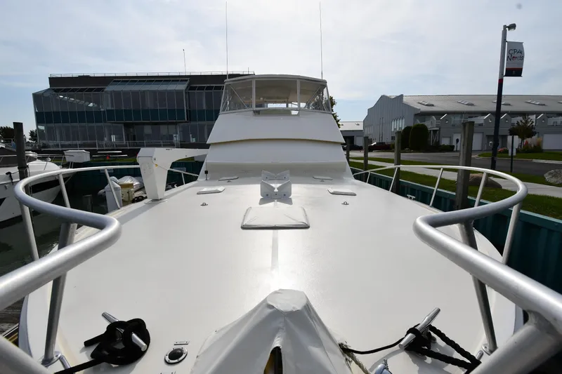 Slide: The Image of 1990 Viking 53 Convertible yacht docked, showcasing spacious deck and sleek design. - 10