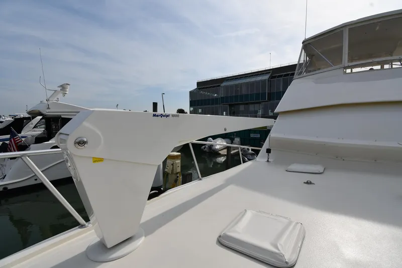 Slide: The Image of 1990 Viking 53 Convertible yacht deck with davit, docked at marina. - 12