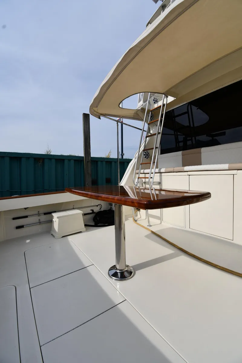 Slide: The Image of 1990 Viking 53 Convertible yacht deck with ladder and seating area. - 16
