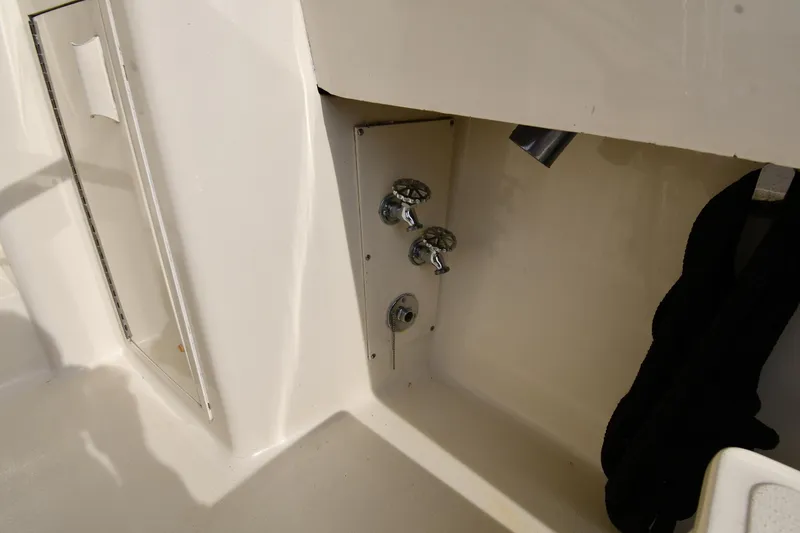 Slide: The Image of 1990 Viking 53 Convertible yacht interior with faucet and storage compartment. - 18