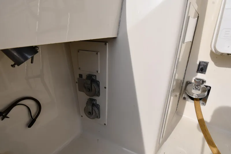 Slide: The Image of Electrical outlets and hose connection on a 1990 Viking 53 Convertible boat. - 19