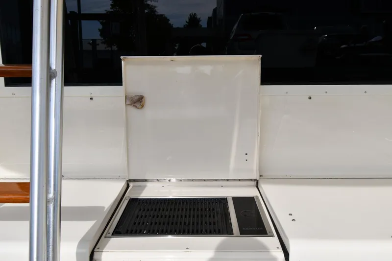 Slide: The Image of 1990 Viking 53 Convertible yacht deck with grill and storage compartment. - 20